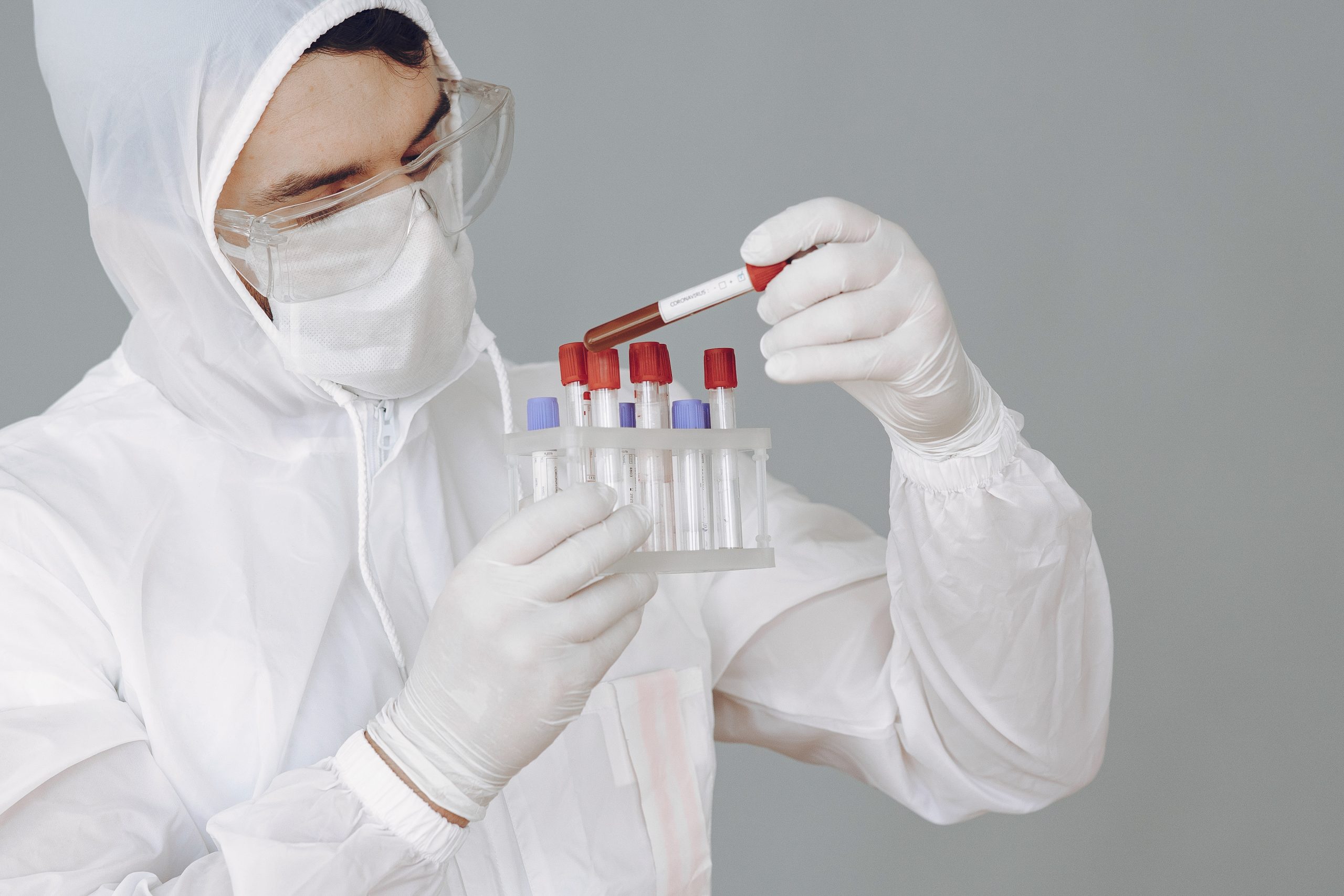 Man in protective suit and glasses in studio